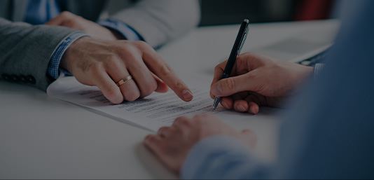 Someone signing a document